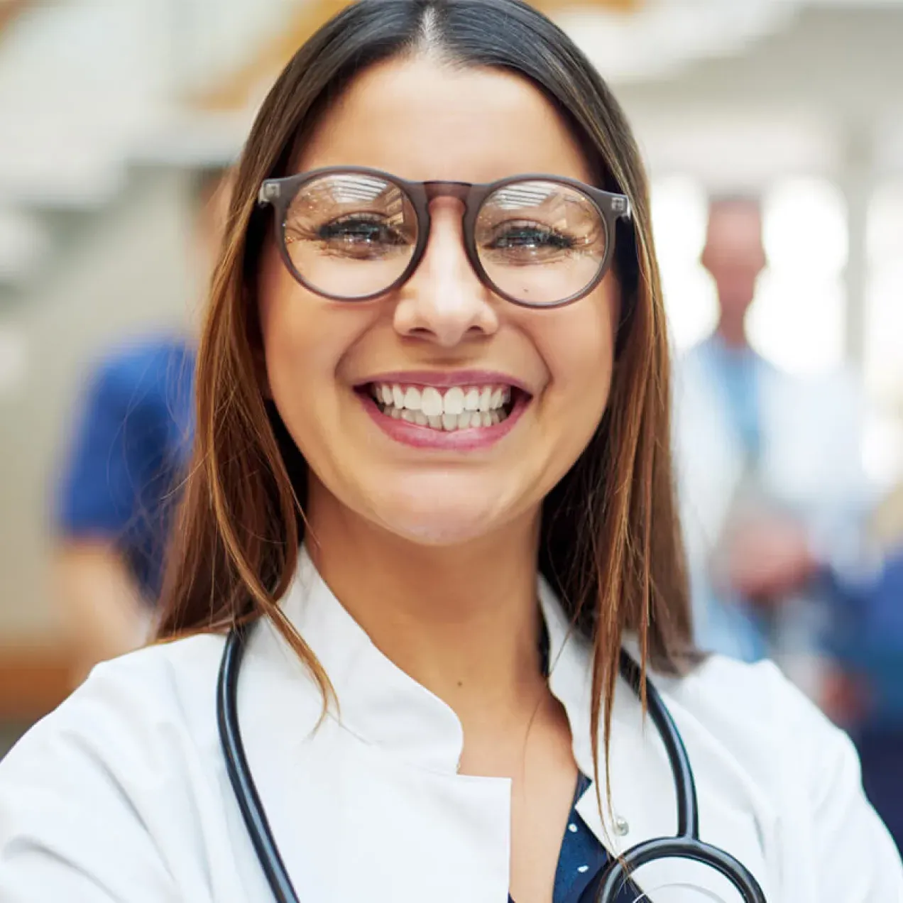 Family nurse practitioner with DNP smiling with team of medical professionals